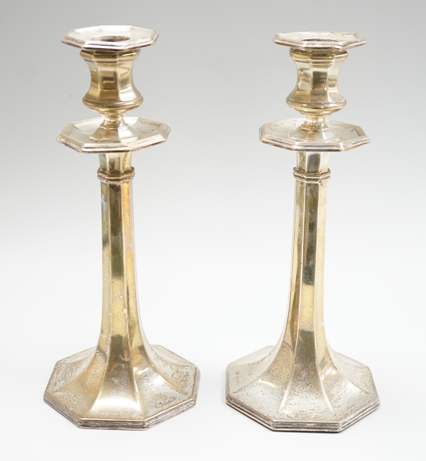 A pair of George V silver mounted candlesticks, with panelled stems, by James Dixon & Sons, Sheffield, 1913, height 21.8cm, weighted.